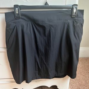 Calvin Klein black athletic skirt with bike shorts underneath. Size medium. NWOT